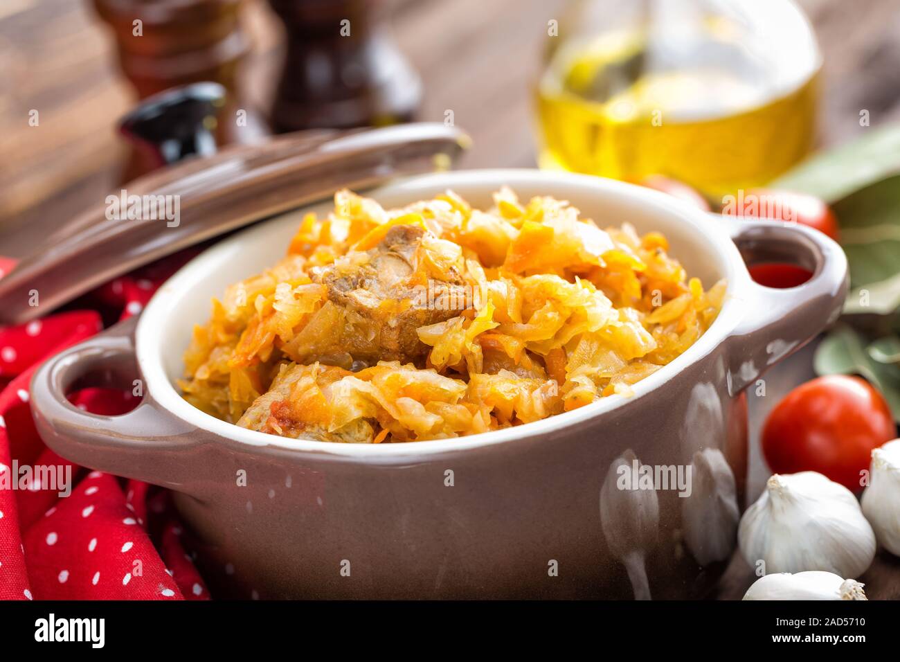 Stewed cabbage with meat on dark rustic wooden background Stock Photo
