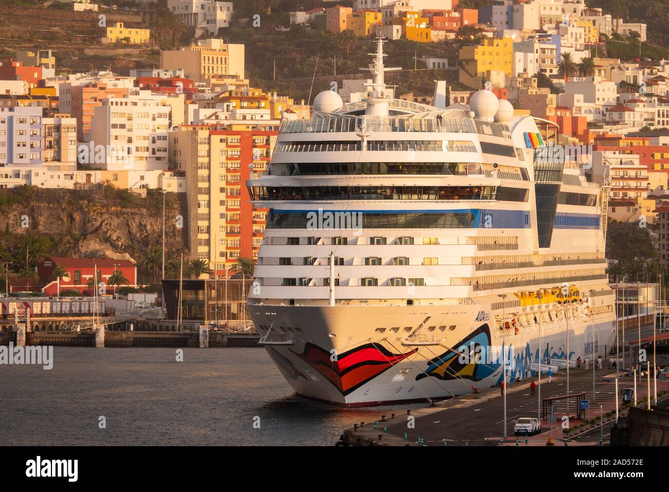 Cruise Ship, Aida Stella in the port of La Palma with houses in the background. Stock Photo