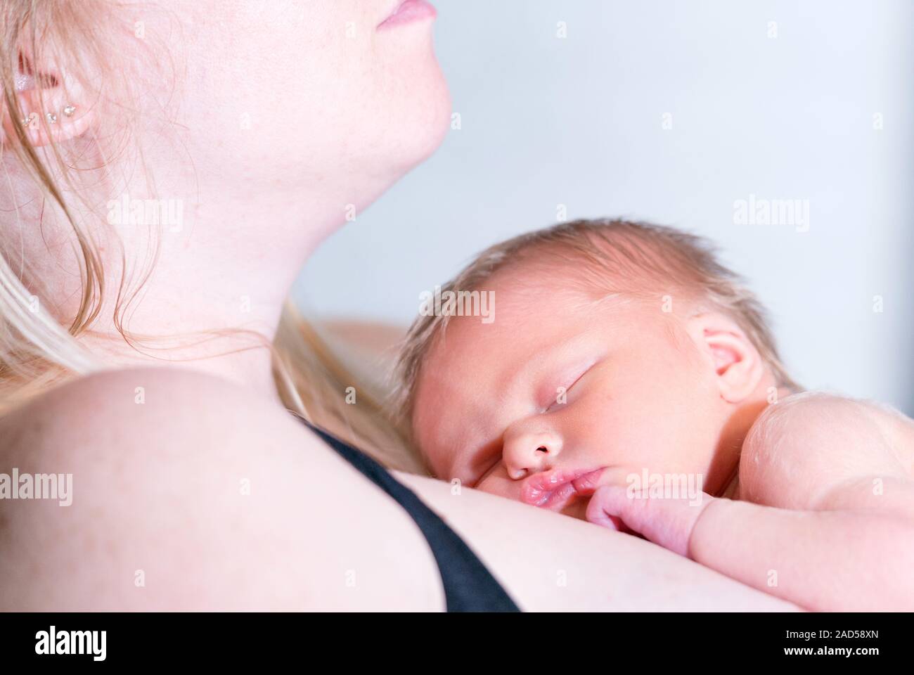 Newborn Baby Girl Sleeping Peacefully on Her Mother Stock Photo - Alamy