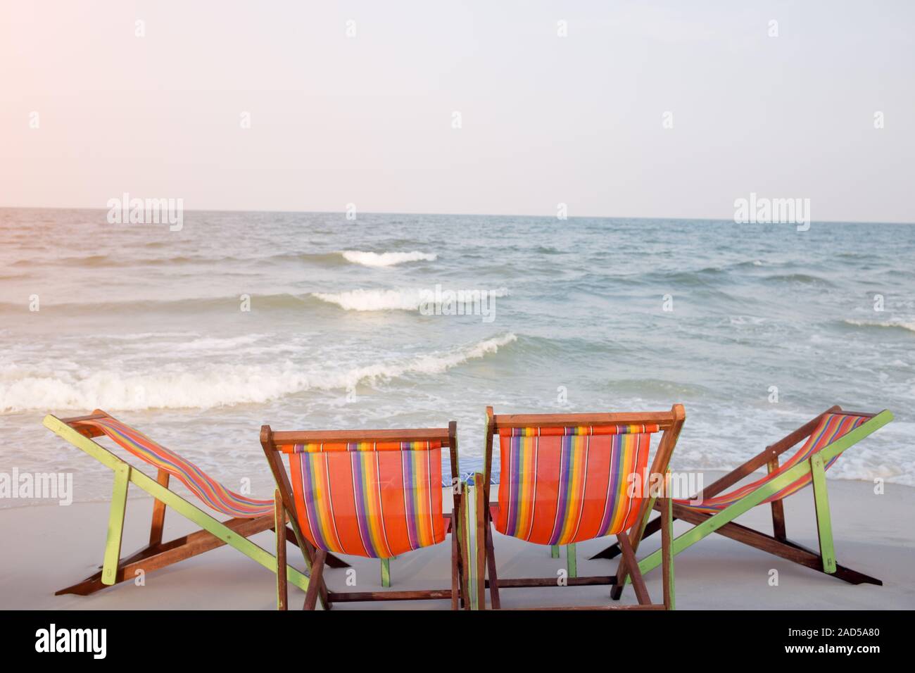 Palm tree two deck chairs hi-res stock photography and images - Alamy