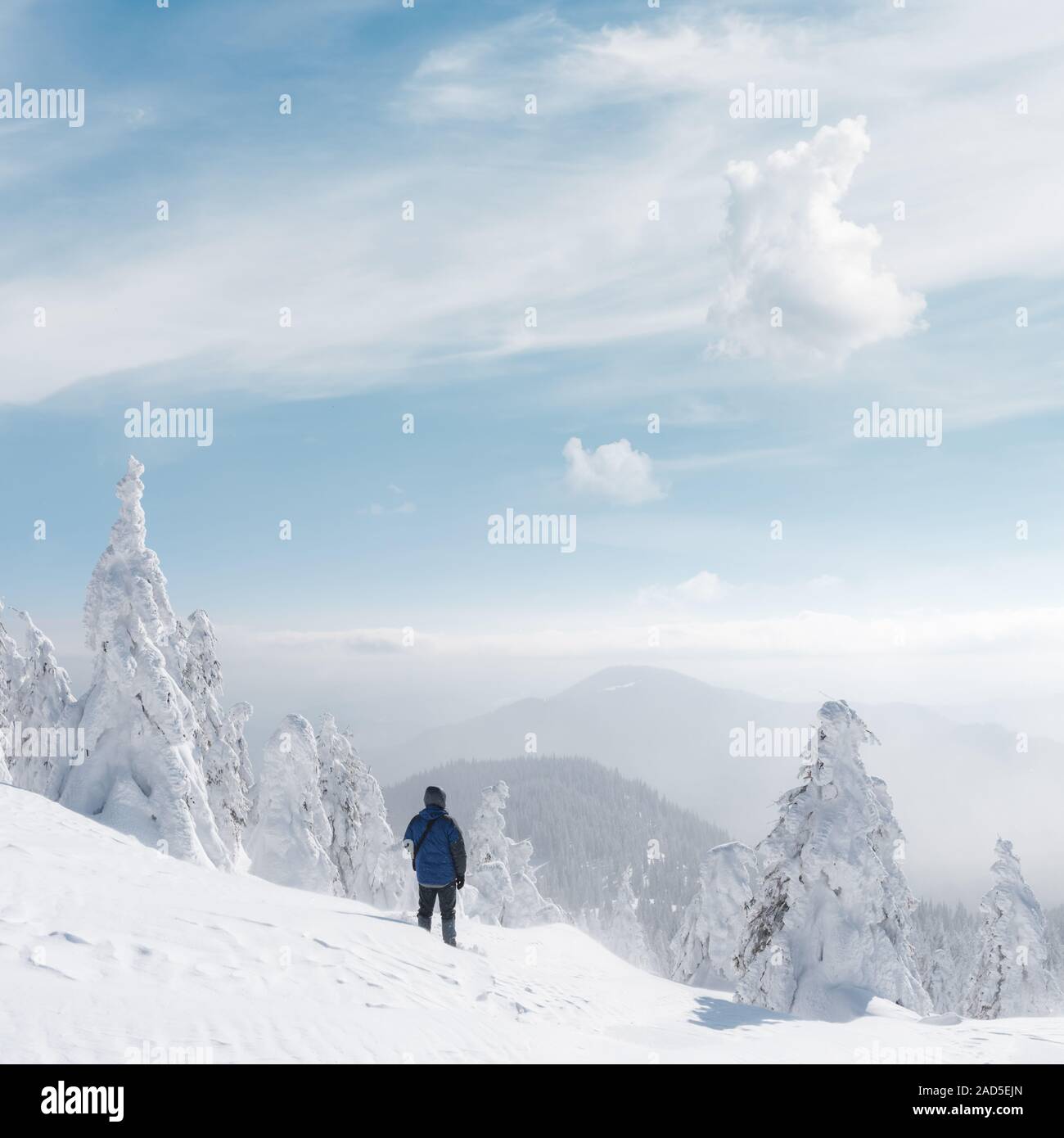 Alone tourist with a backpack in the high mountains in winter time. Travel concept Stock Photo