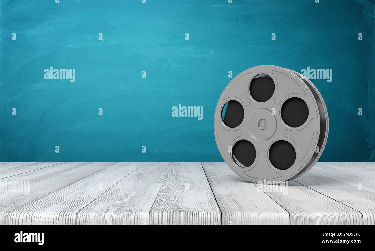 3d rendering of film reel on white wooden floor and dark turquoise background. Digital art. Management and production. Cinema industry. Stock Photo