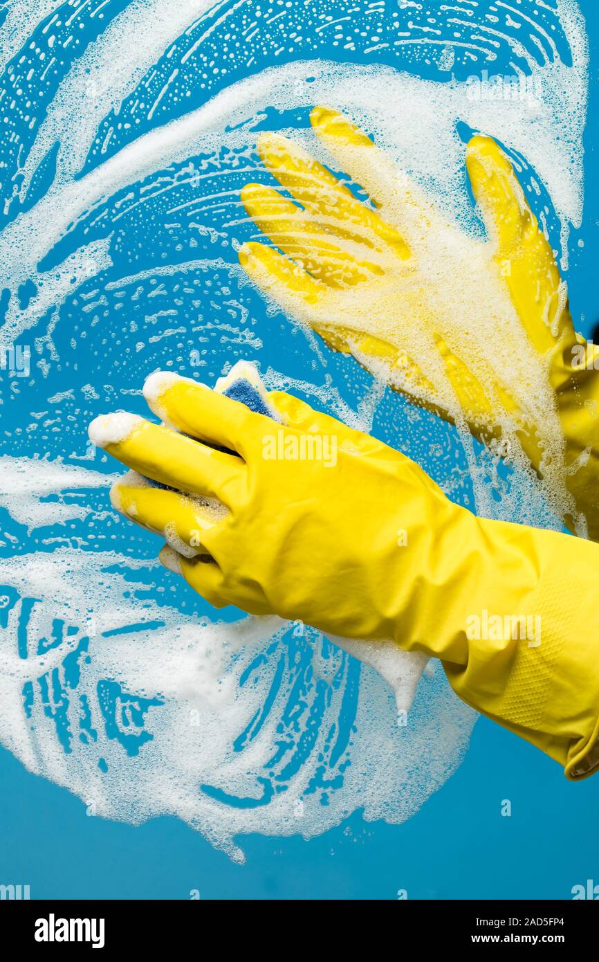 Person washes window with foam Stock Photo