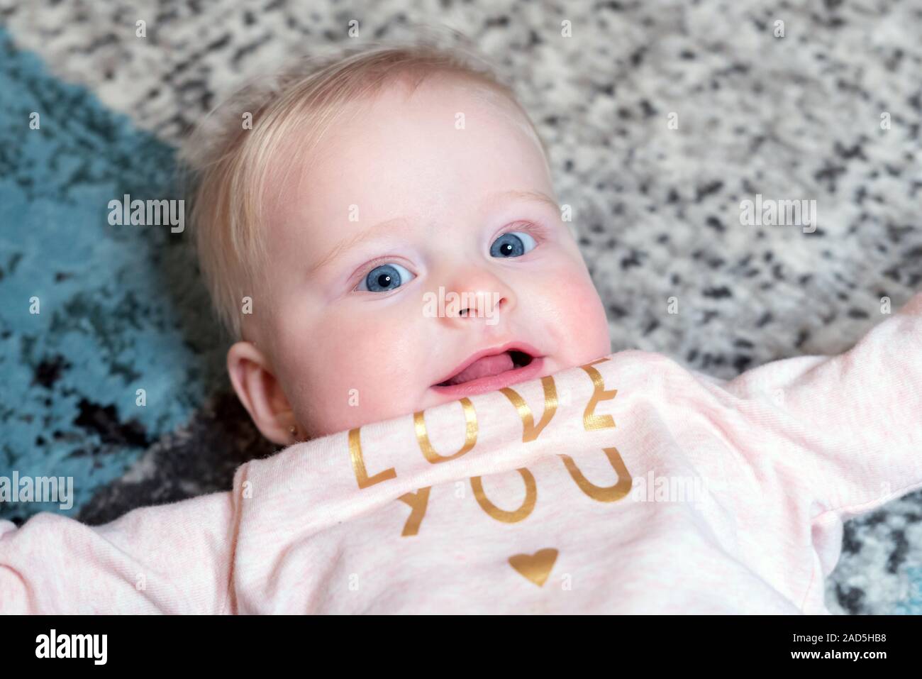 Happy Smiling Baby with Blue Eyes - Age 6 Months Stock Photo