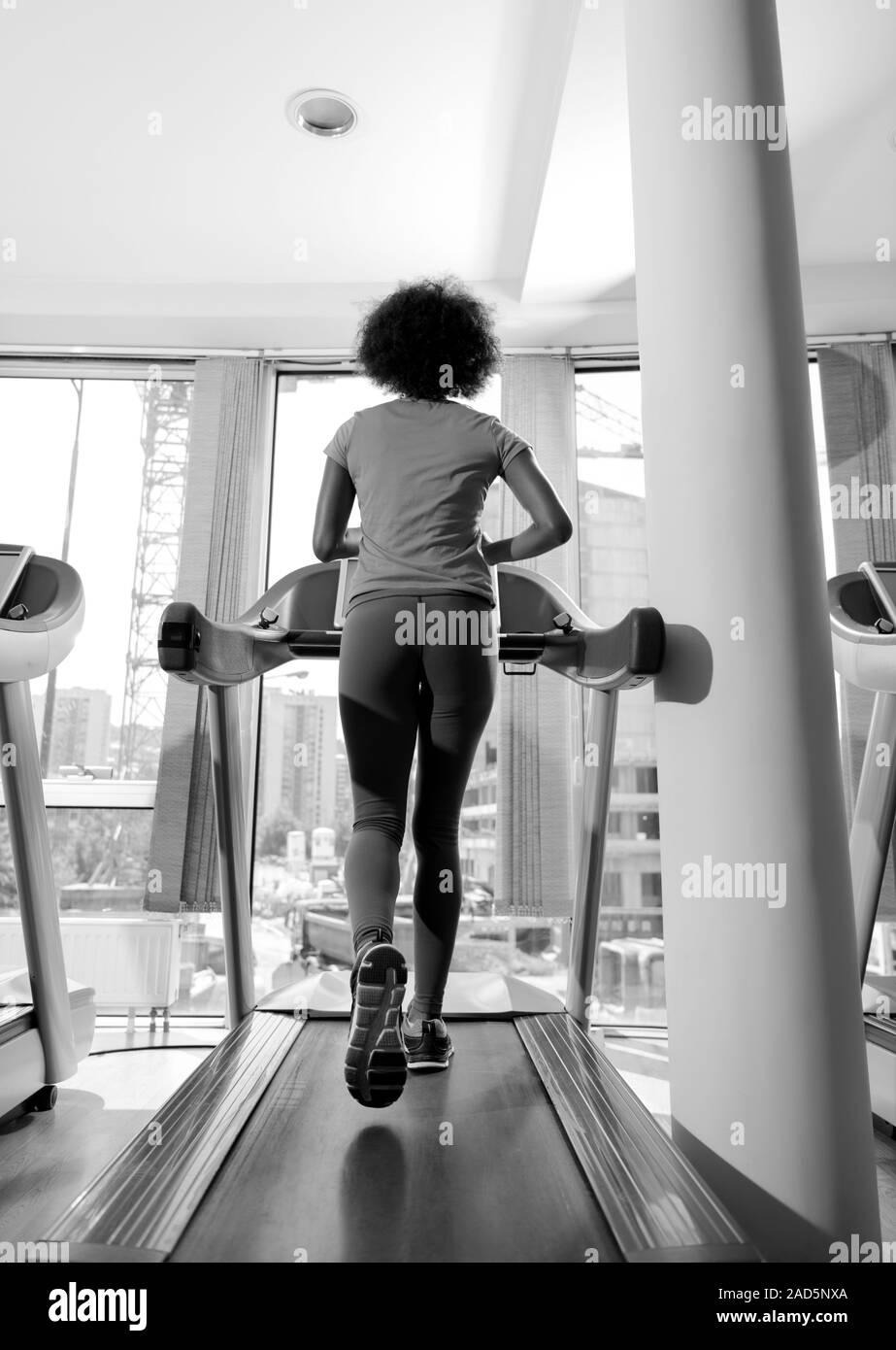 afro american woman running on a treadmill Stock Photo