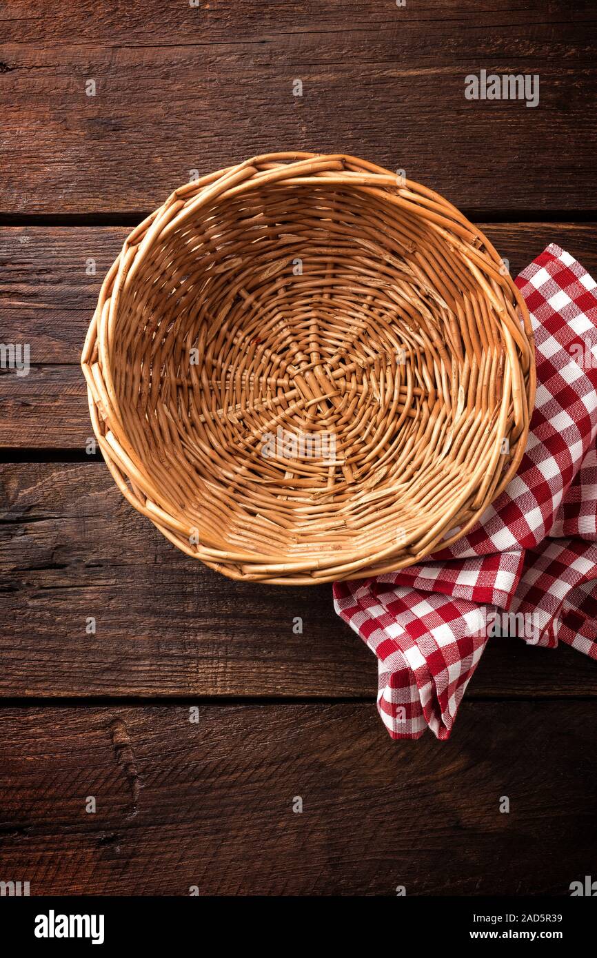 Empty wicker basket on a wooden background, top view Stock Photo
