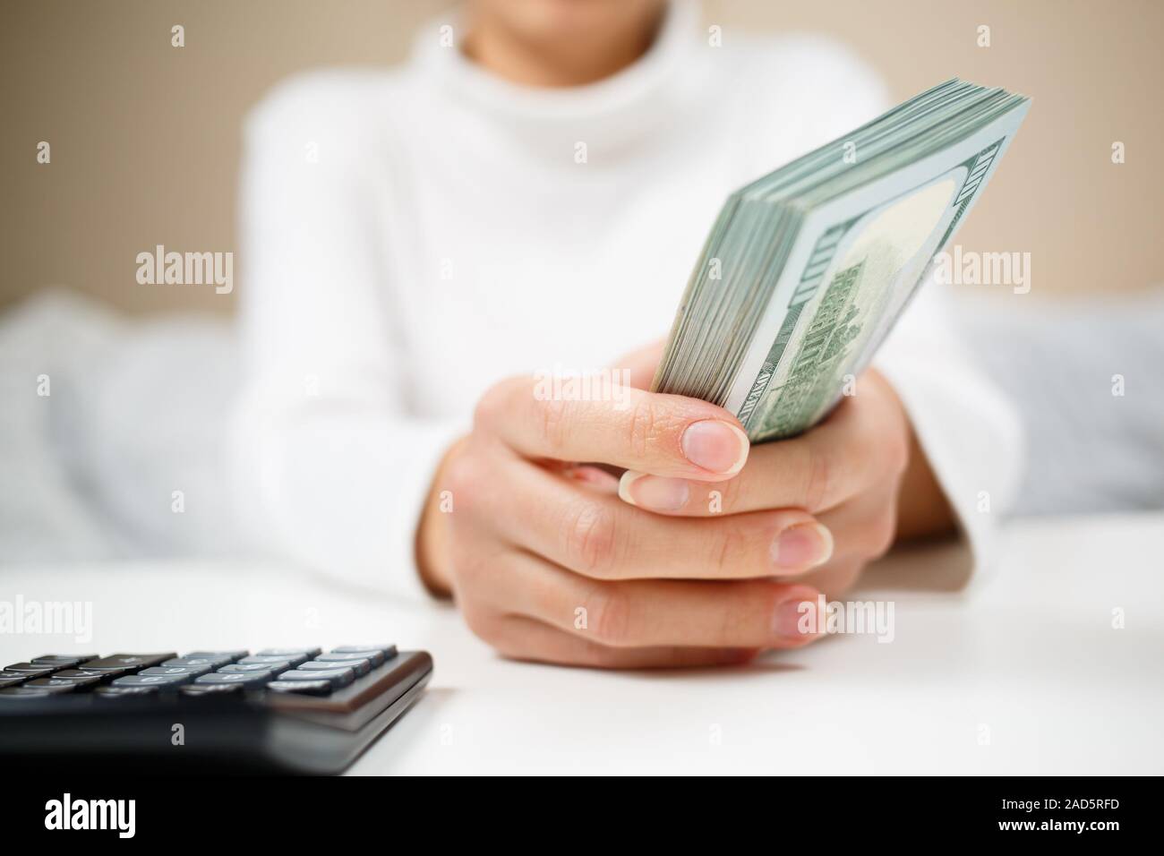 Woman hand hold cash dollar banknotes. Only hundreds. Stock Photo