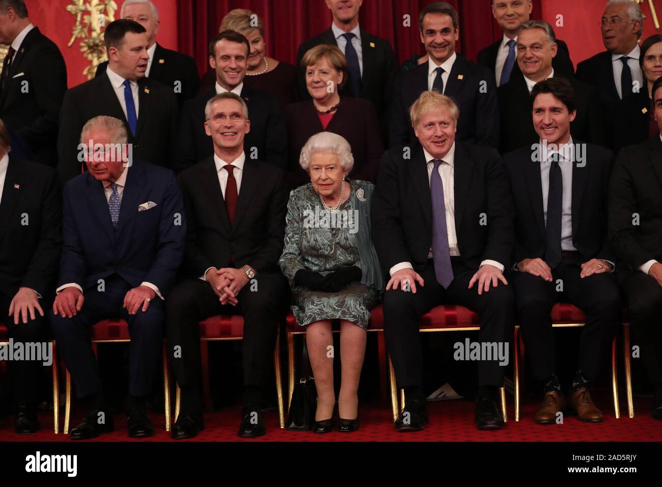 Queen Elizabeth II and Prime Minister Boris Johnson joins other Nato  leaders for a group photograph Chancellor of Germany, Angela Merkel, talks  to Queen Elizabeth II during a reception at Buckingham Palace,