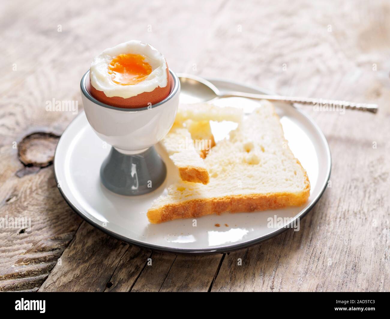 soft boiled egg in Cup on a wooden table Stock Photo