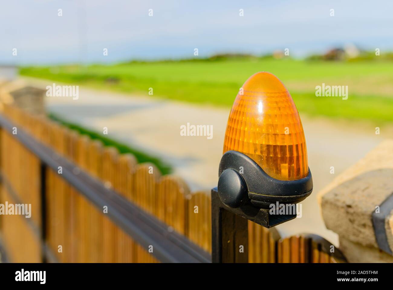 Automatic gate - wooden gate with warning lamp detail Stock Photo
