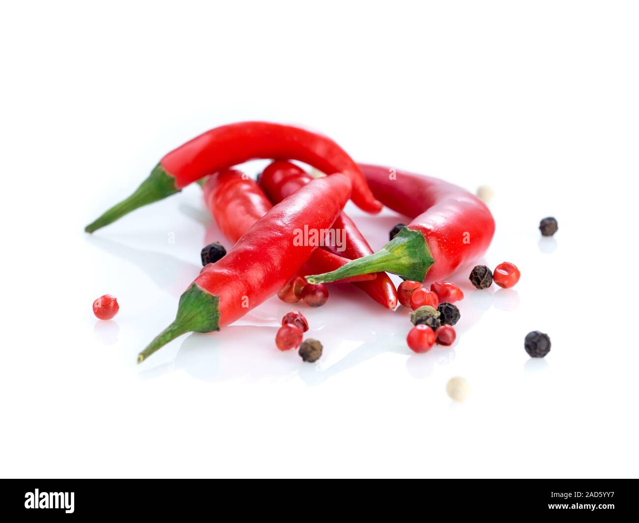 Red cayenne pepper and peppercorn on white background, side view Stock