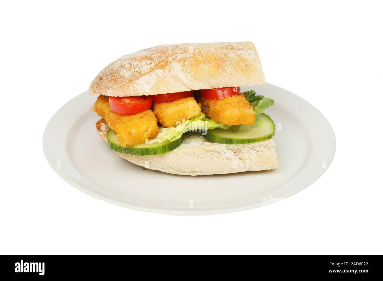 Fish fingers and salad in a ciabatta roll on a plate isolated against white Stock Photo
