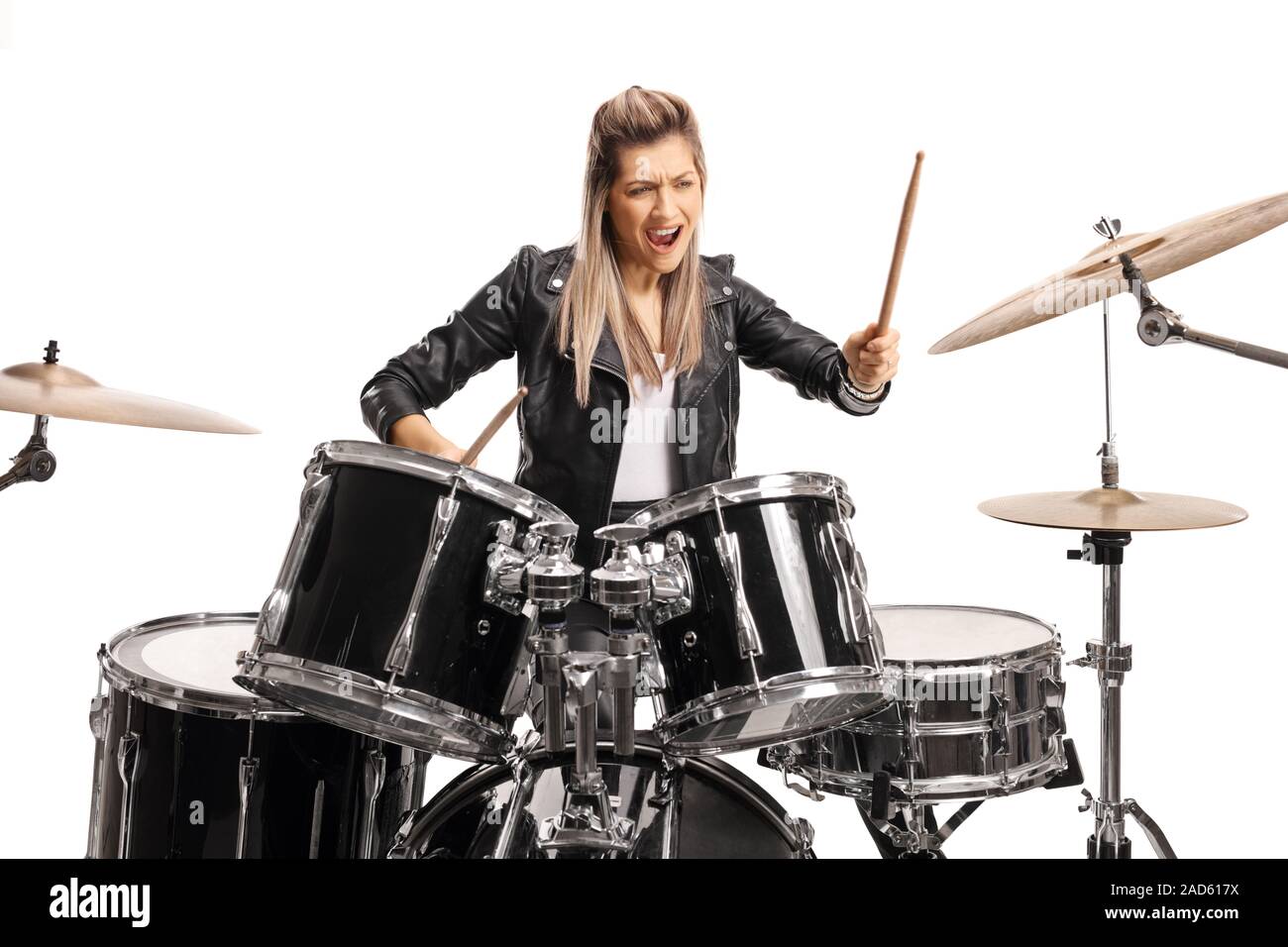 Female drummer playing on a set of drums isolated on white background Stock Photo