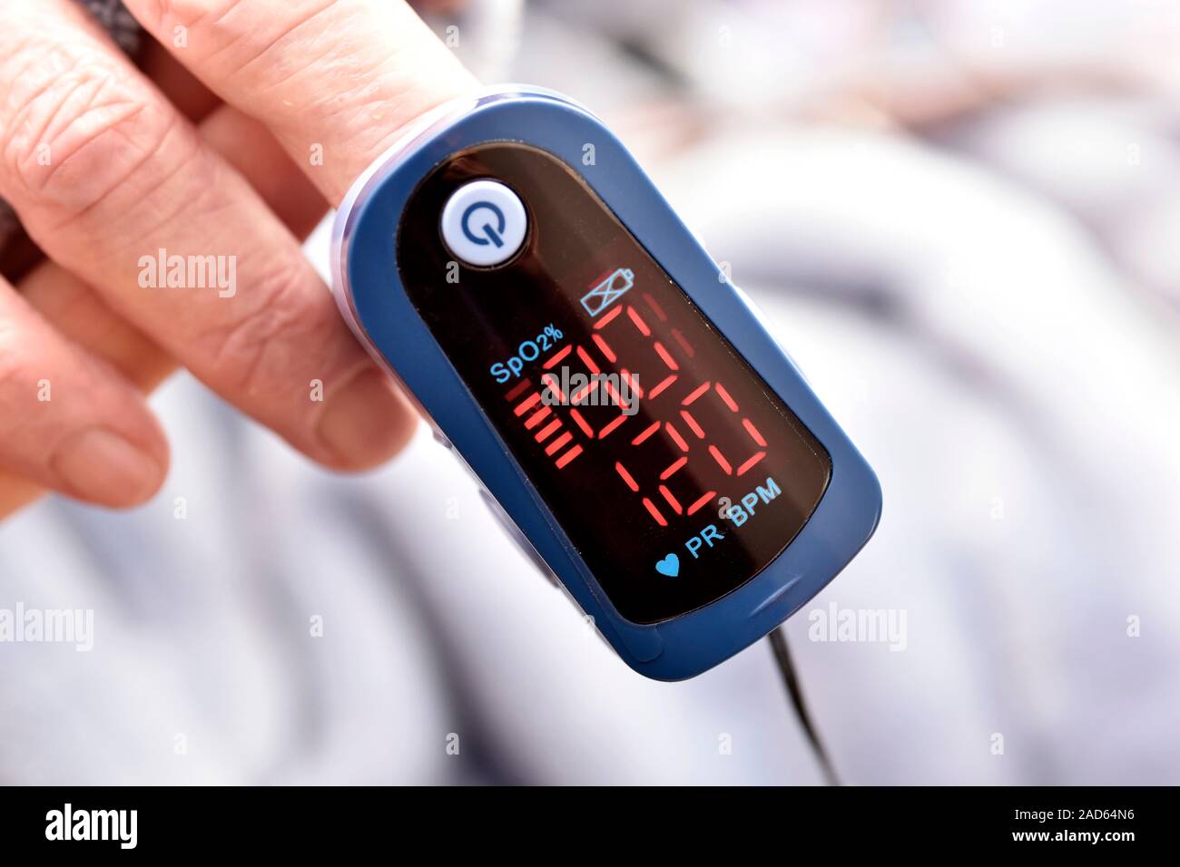 Pulse oximeter. Closeup of a pulse oximeter on the finger of an 81