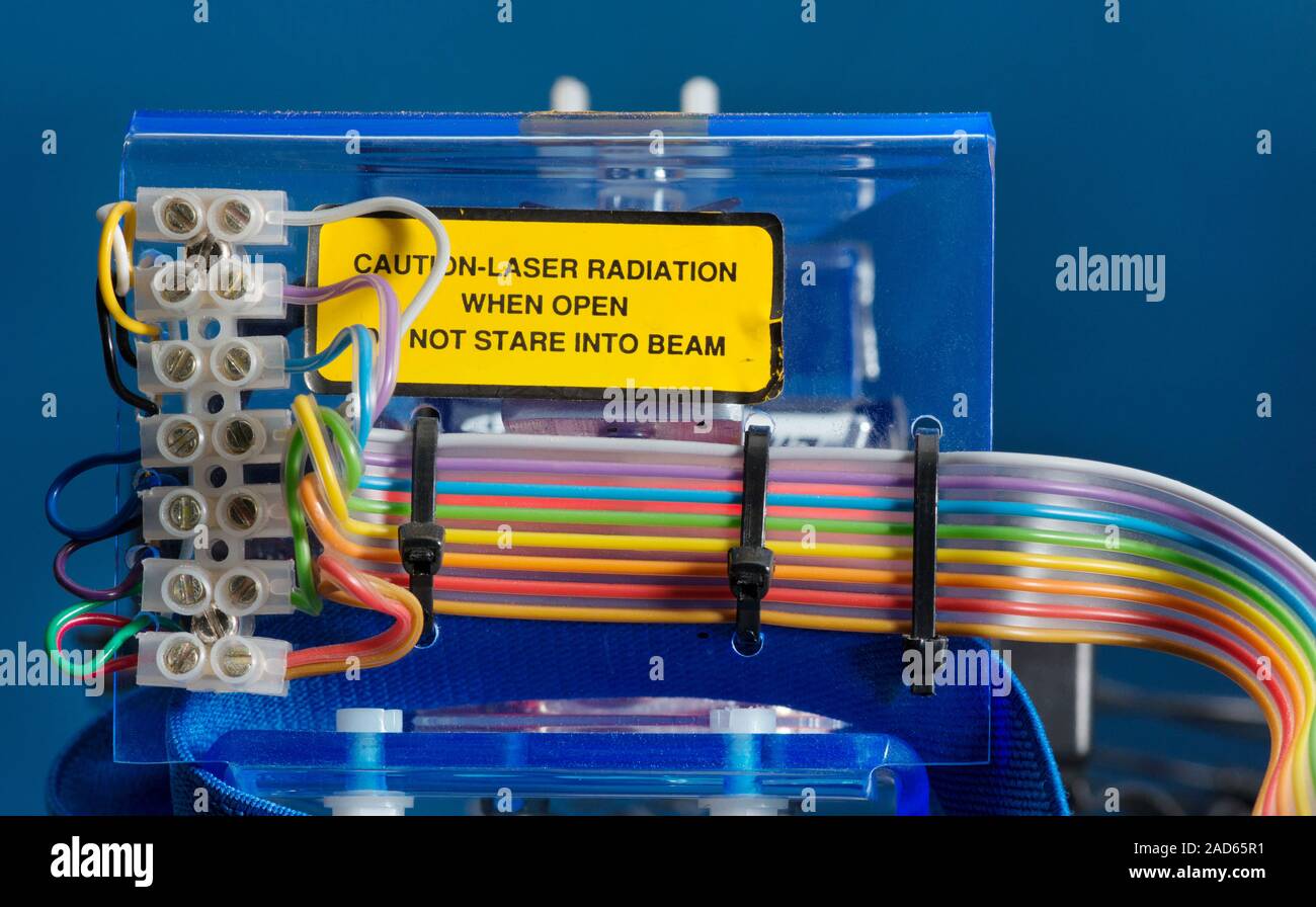 Laser. Wires and connectors forming part of a laser, with a warning