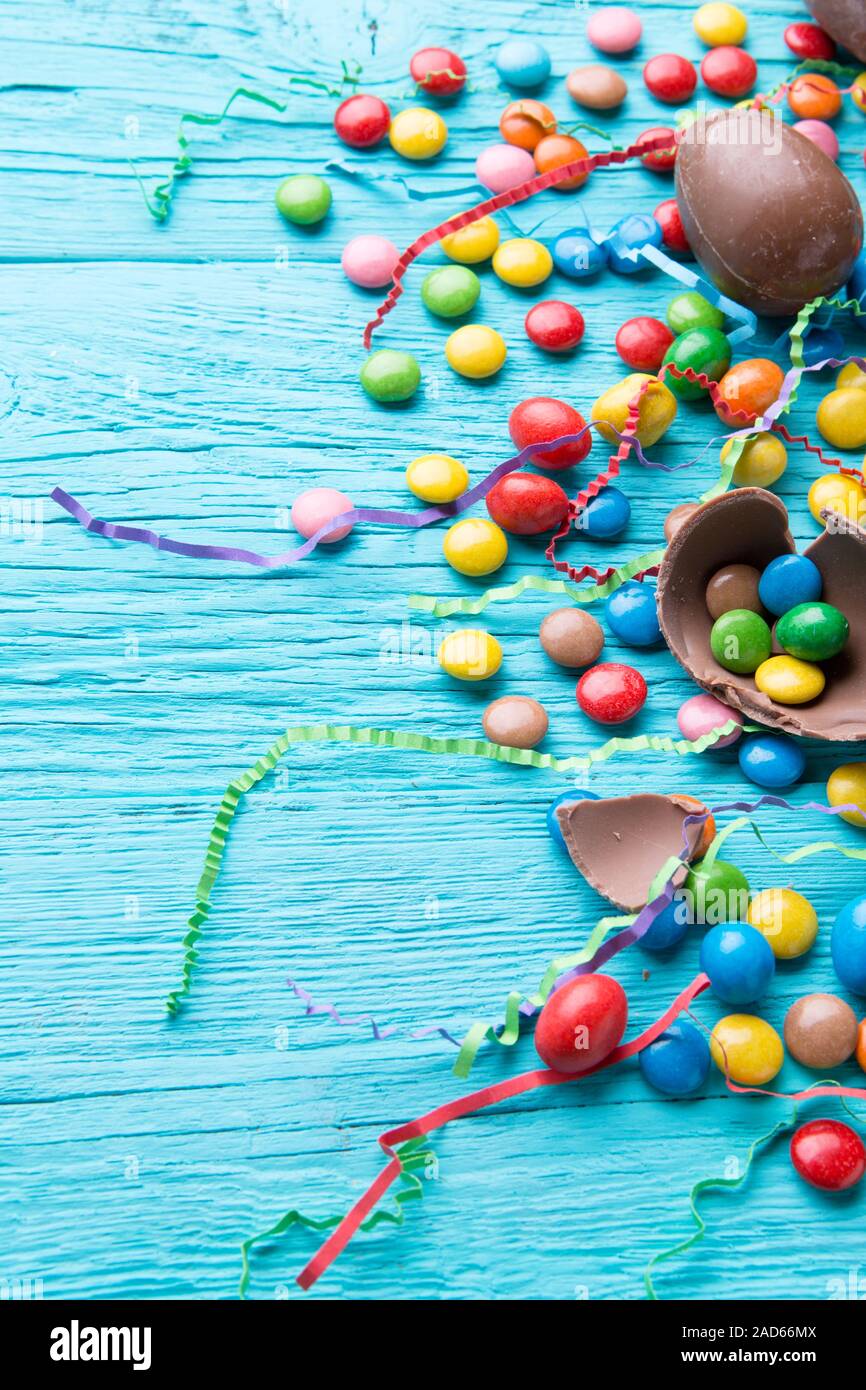 Multicolored dragees, chocolate eggs, ribbons Stock Photo