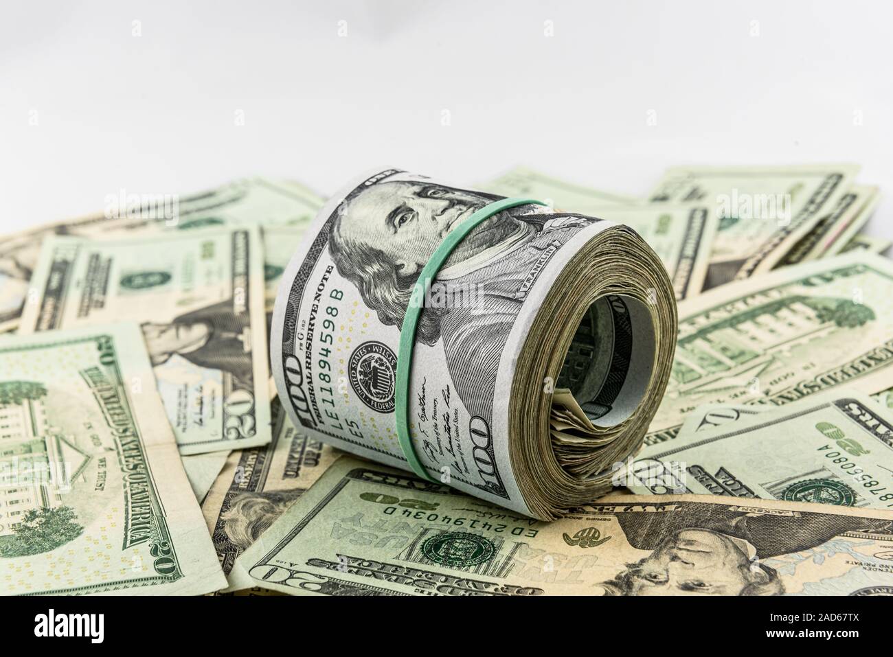 Roll of US Currency, a Bankroll, on a blanket of paper money Stock