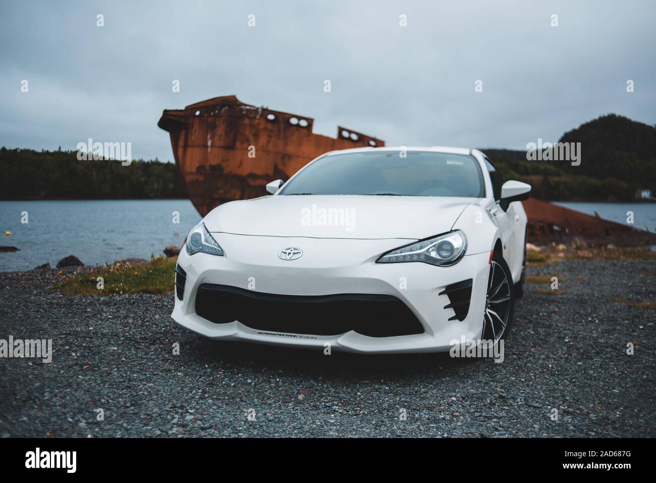stock 2017 toyota gt86 white parked next to the water and a boat Stock Photo