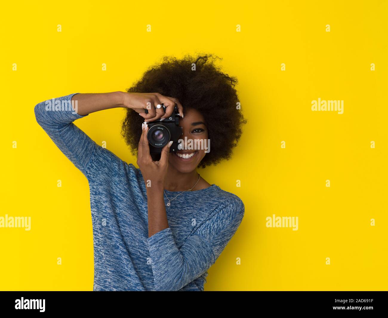 young african american girl taking photo on a retro camera Stock Photo ...