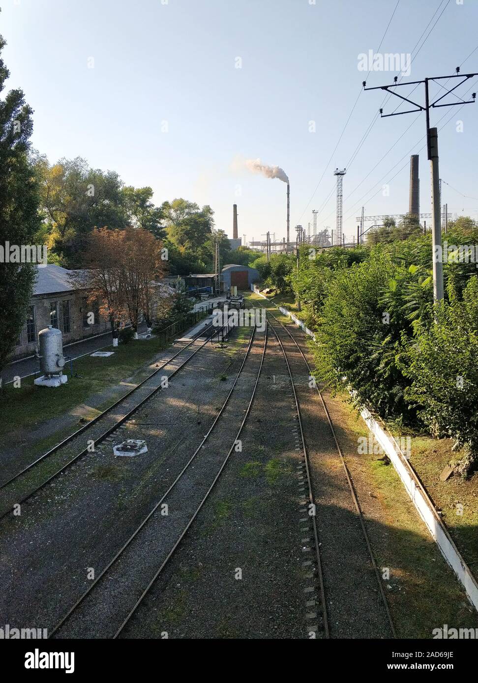 Empty Rails Railway. Empty rails on a background of smoking chimneys of a plant ...