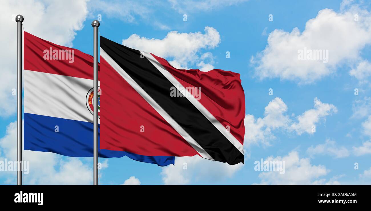 Paraguay and Trinidad And Tobago flag waving in the wind against white cloudy blue sky together. Diplomacy concept, international relations. Stock Photo