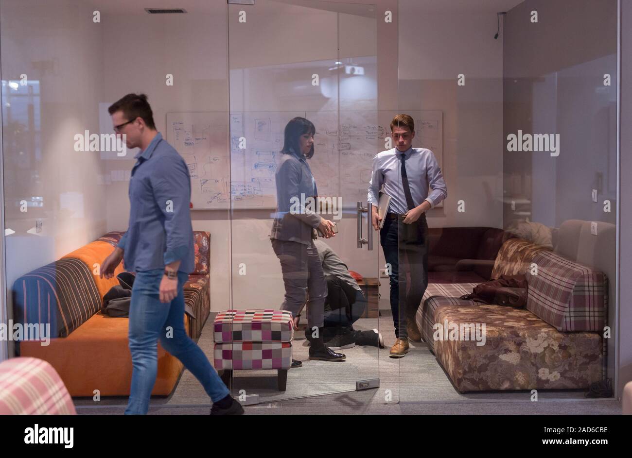 software developers sleeping on sofa in creative startup office Stock Photo