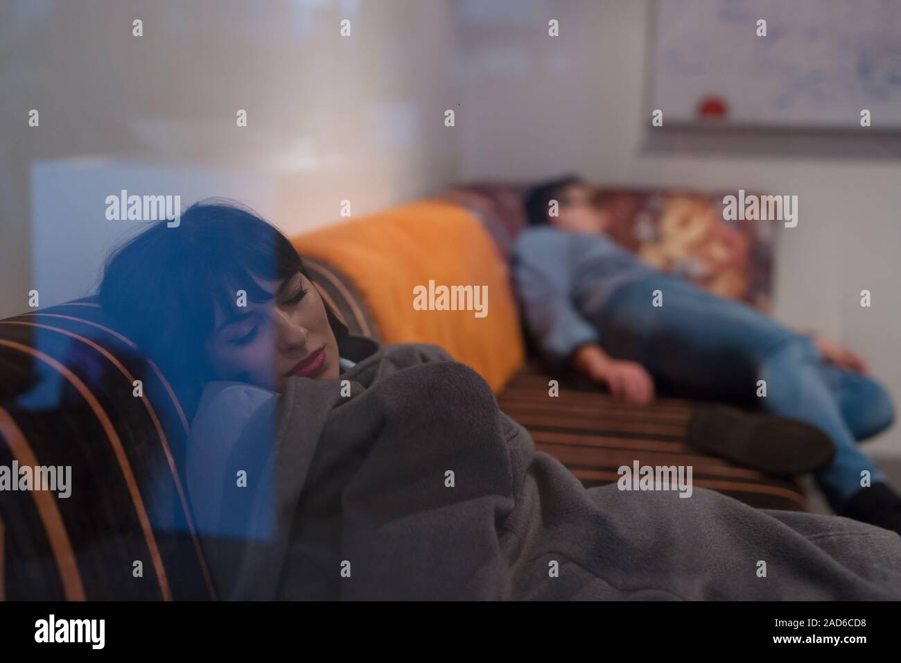 software developers sleeping on sofa in creative startup office Stock Photo