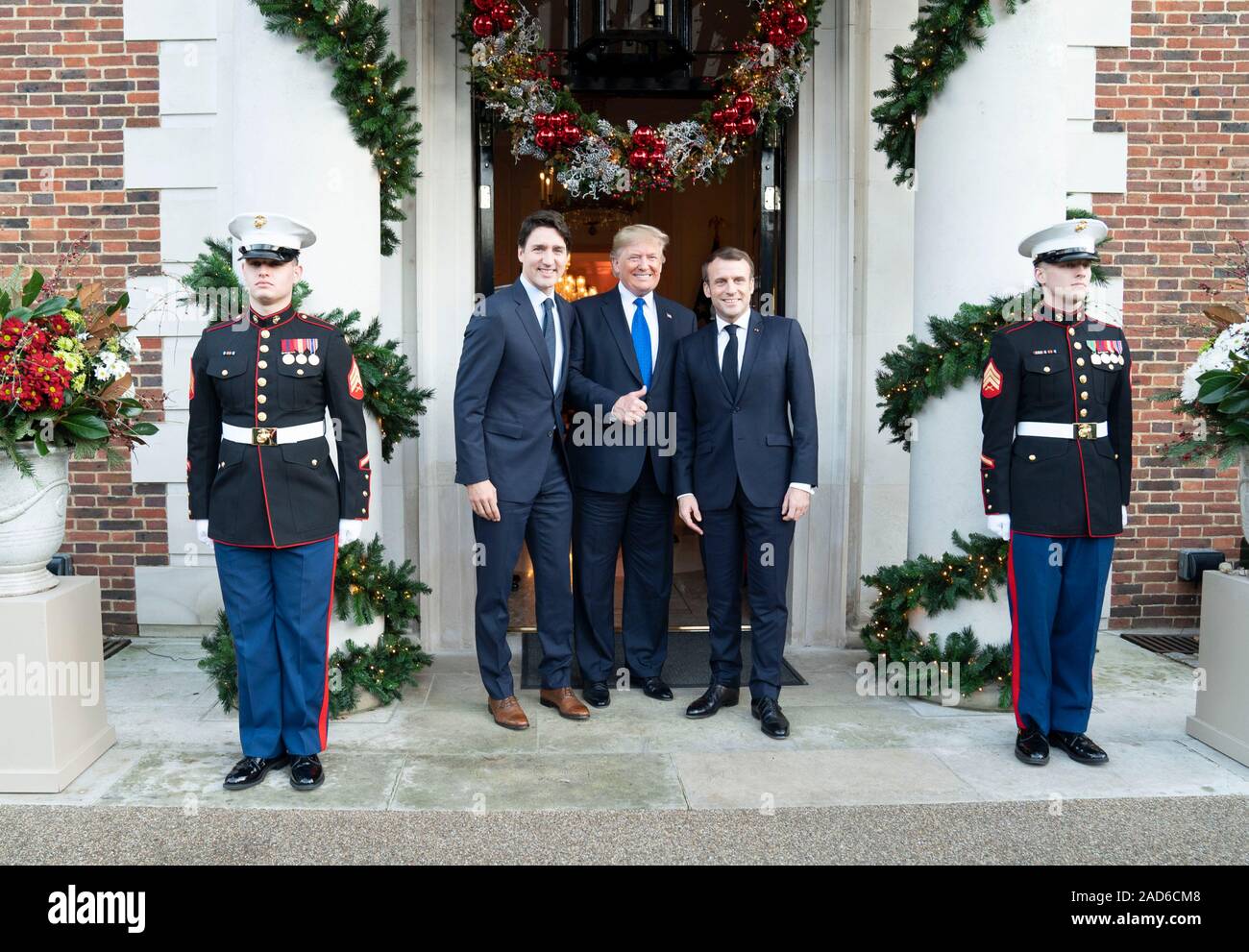 London, UK. 03 December, 2019. U.S. President Donald Trump stands with Canadian Prime Minister Justin Trudeau, left, and French President Emmanuel Macron, right, at the entrance to Winfield House December 3, 2019 in London, UK.  Credit: Shealah Craighead/Planetpix/Alamy Live News Stock Photo