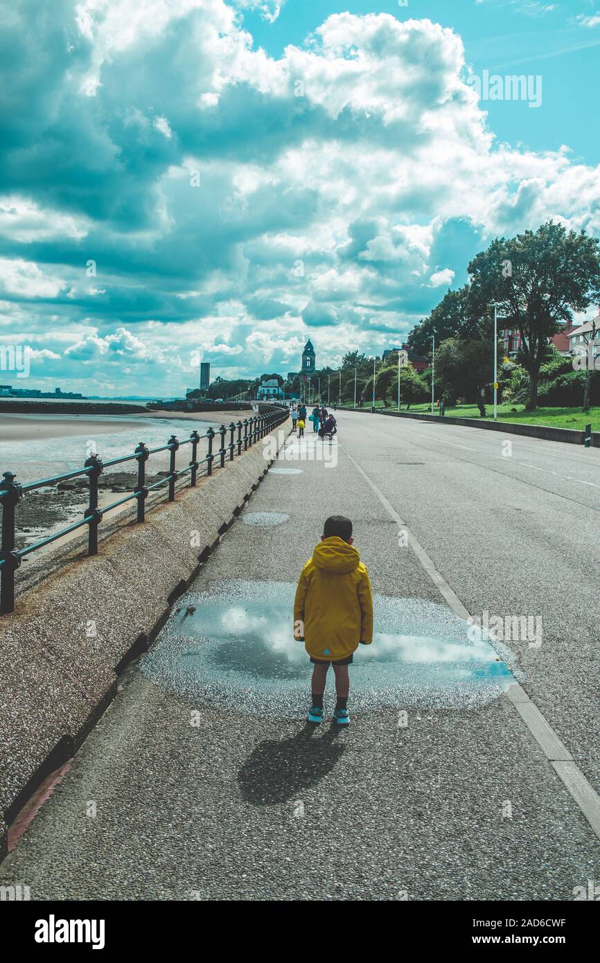 Boy In Yellow Rain Coat Stock Photo