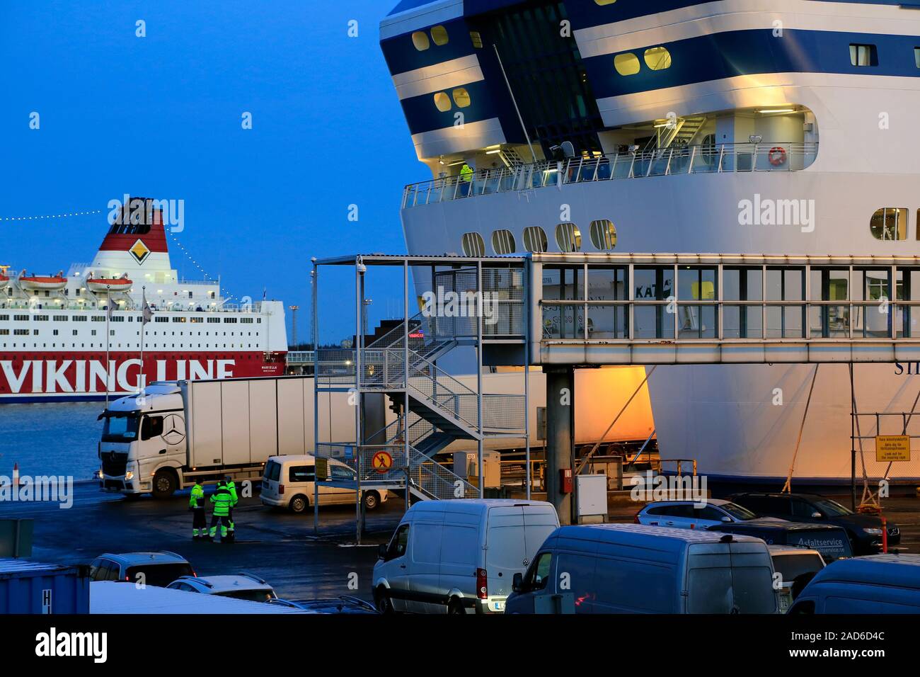 Trucks and cars loading onto Silja Line ferry in South Harbour, Helsinki with freight truck reversing onto ferry. Helsinki, Finland. December 3, 2019. Stock Photo
