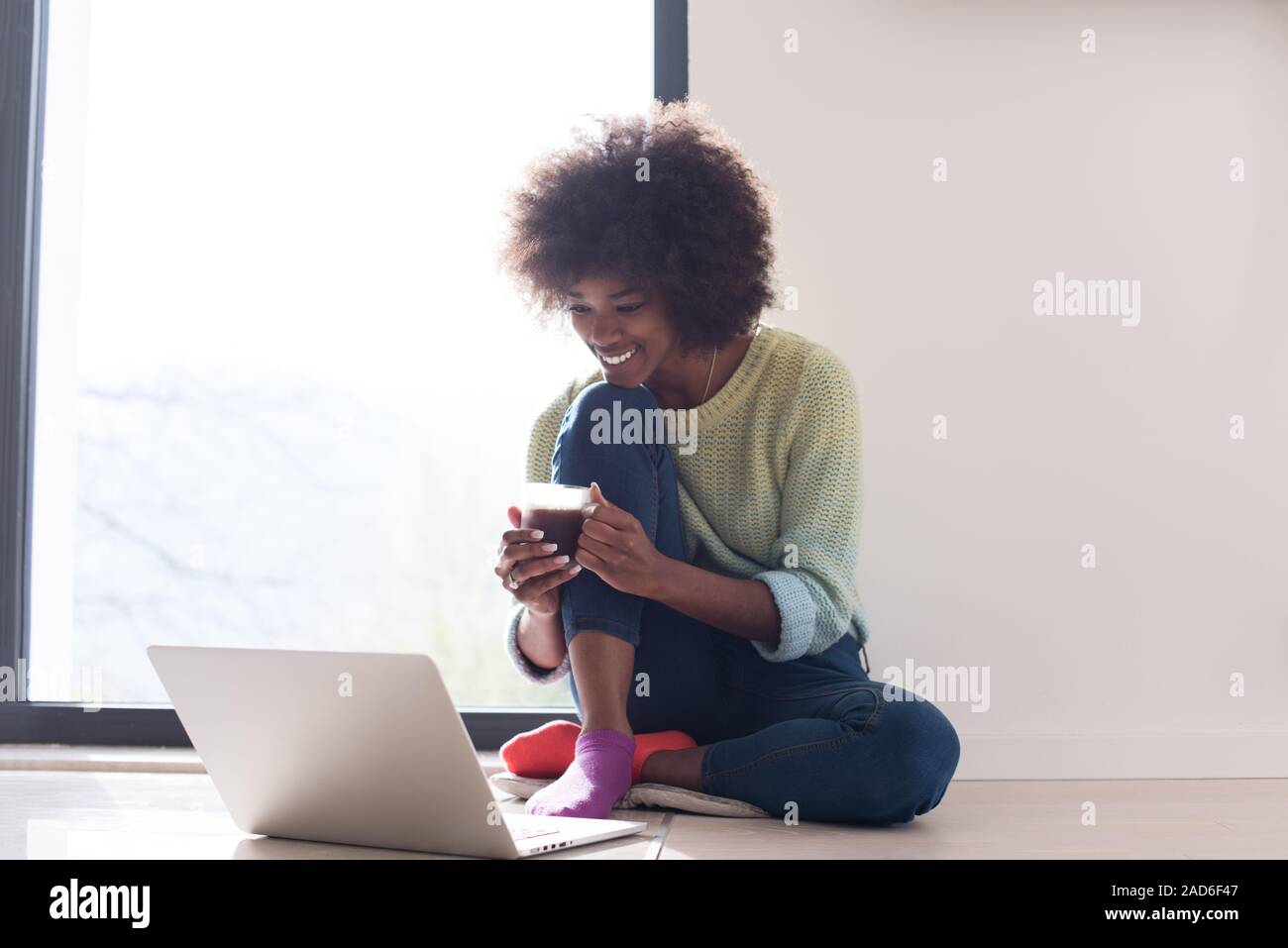 black woman in the living room on the floor Stock Photo - Alamy