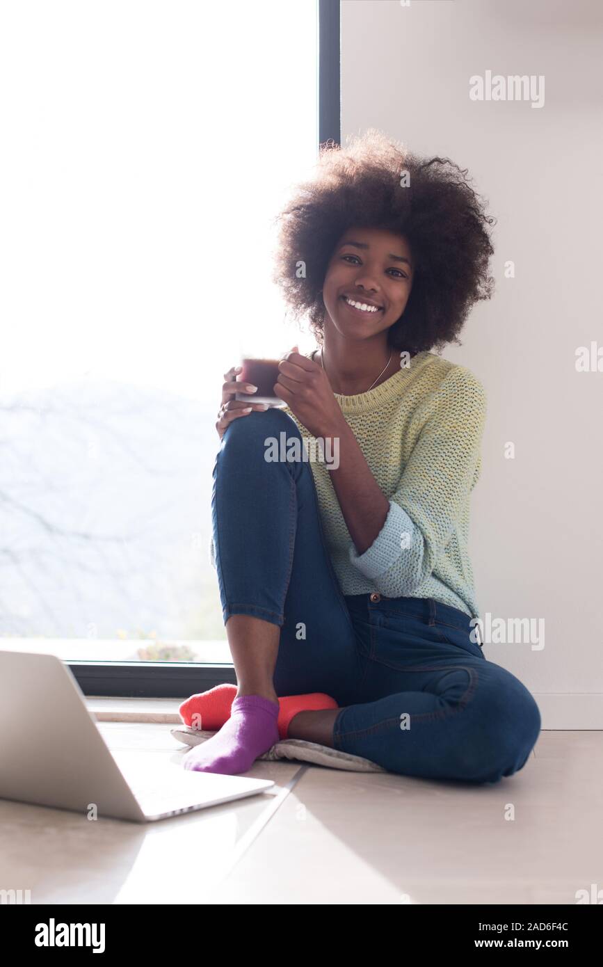 black woman in the living room on the floor Stock Photo - Alamy
