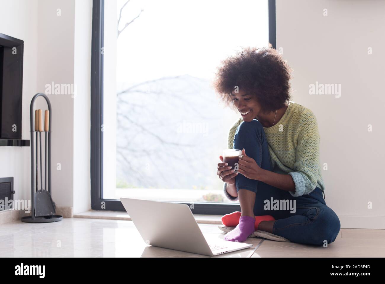 black woman in the living room on the floor Stock Photo - Alamy