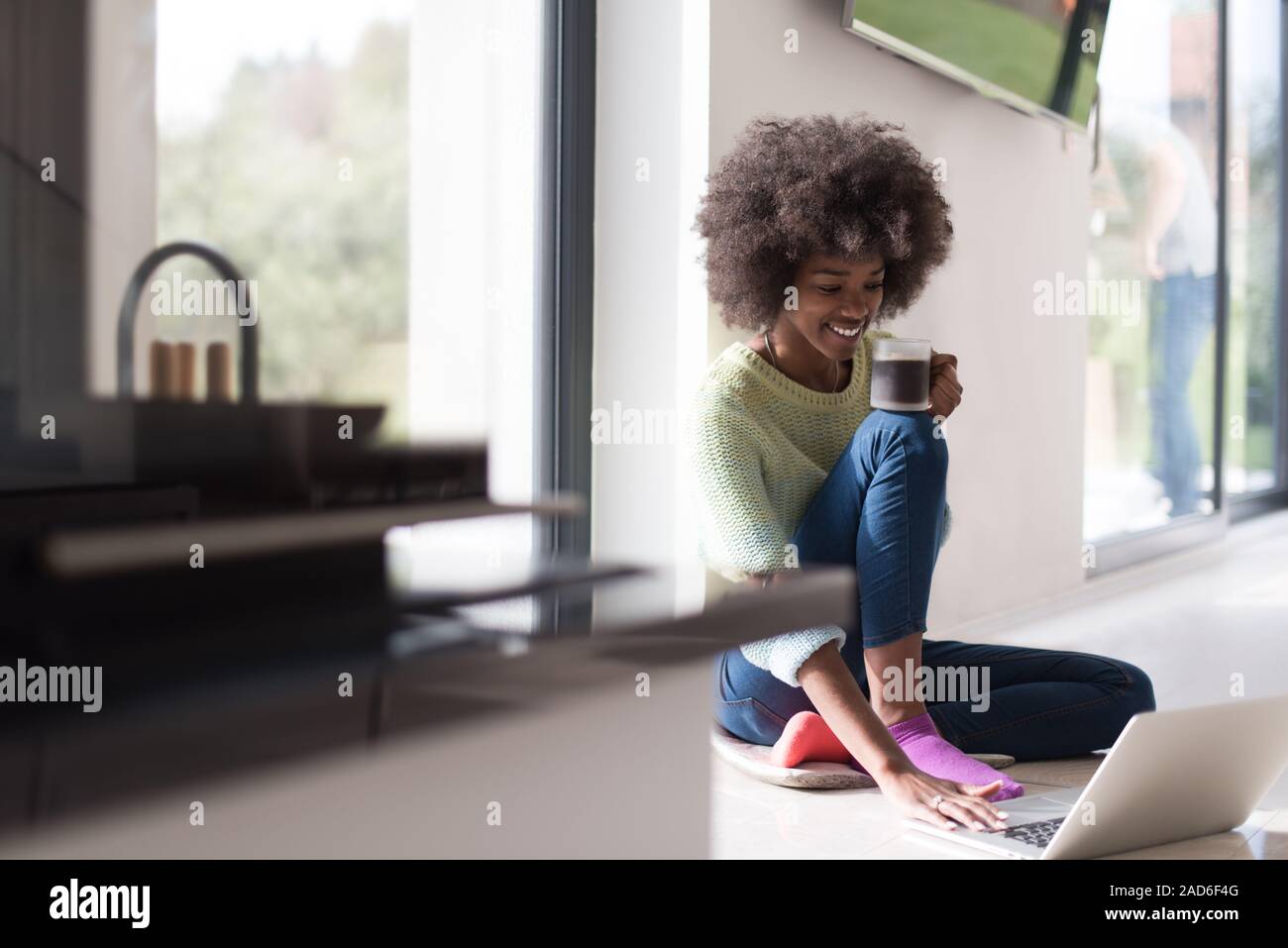 black woman in the living room on the floor Stock Photo - Alamy