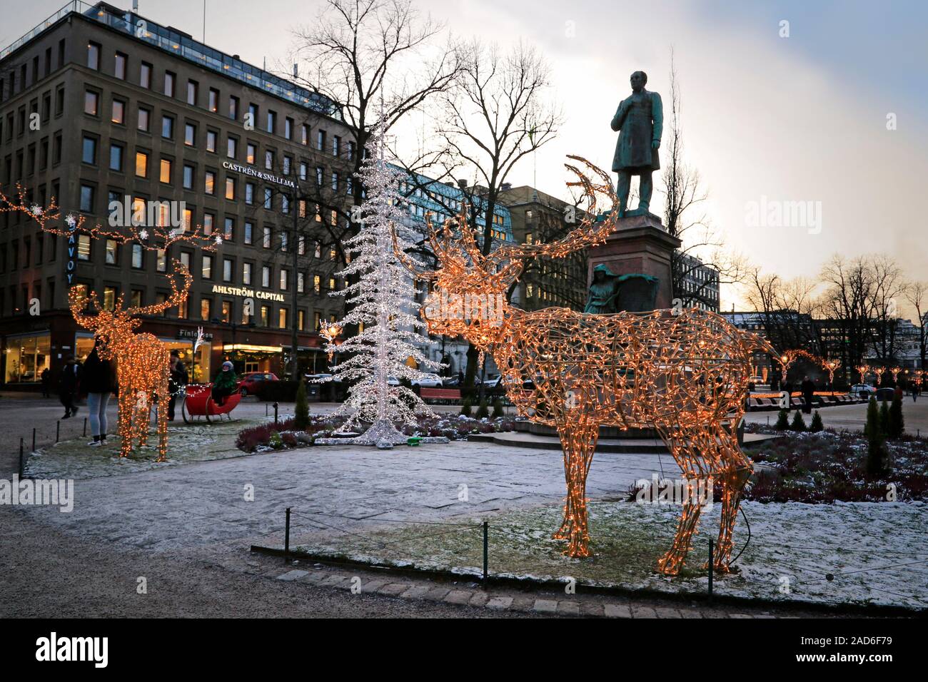 Christmas decorations of a reindeer and Christmas tree in Esplanade park with evening illumination. Helsinki, Finland. December 3, 2019. Stock Photo