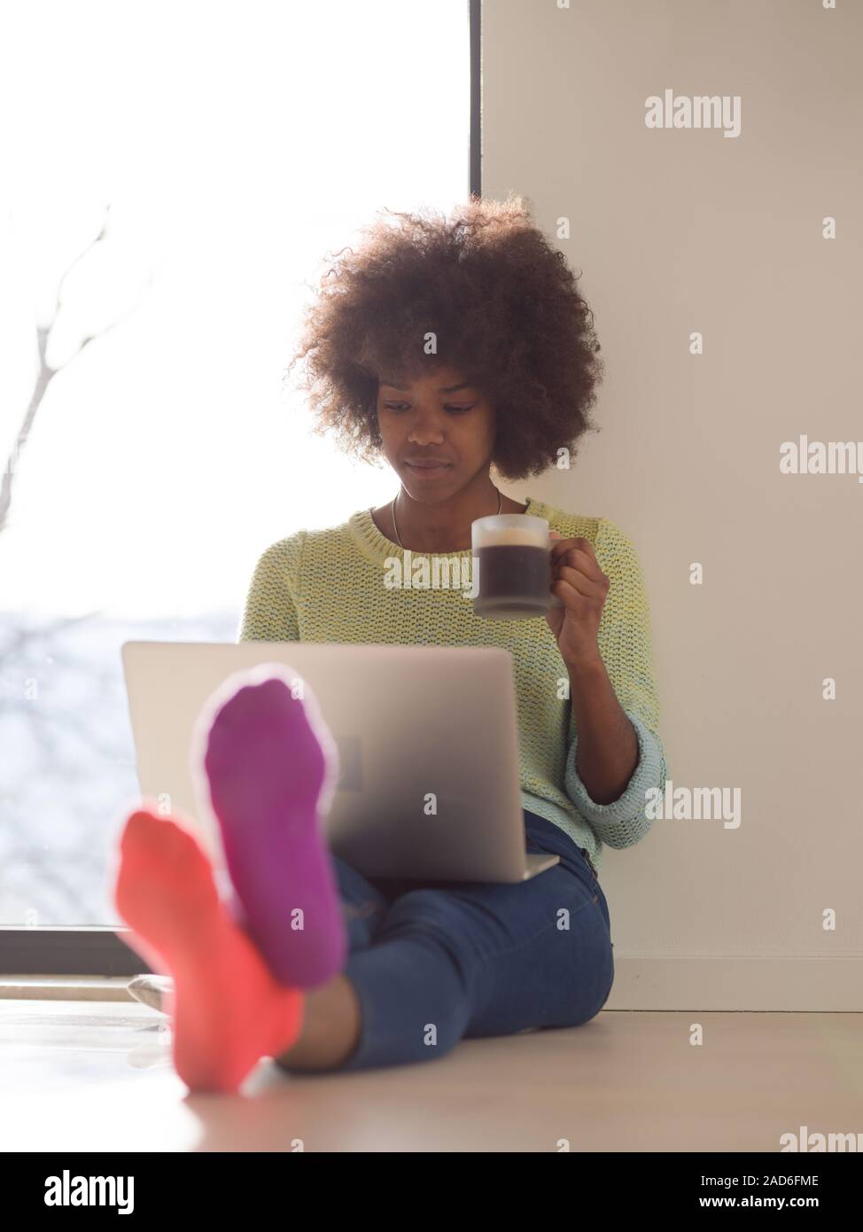 black woman in the living room on the floor Stock Photo - Alamy