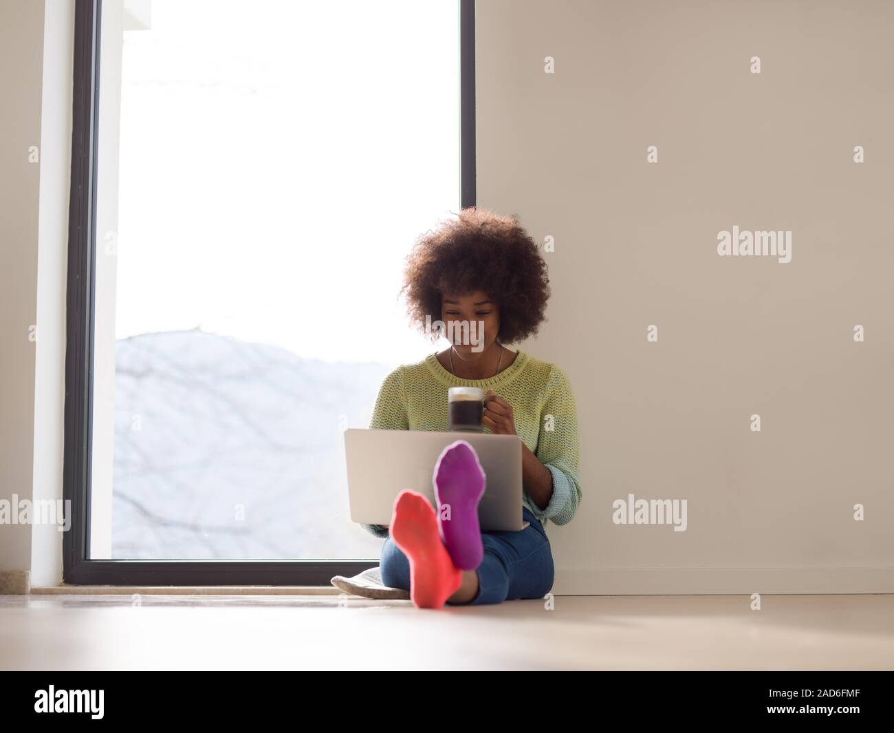 black woman in the living room on the floor Stock Photo - Alamy