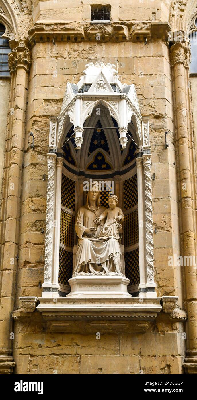 Marble sculpture Madonna of the Rose on an external niche of the Orsanmichele Church in the historic centre of Florence, Unesco Site, Tuscany, Italy Stock Photo