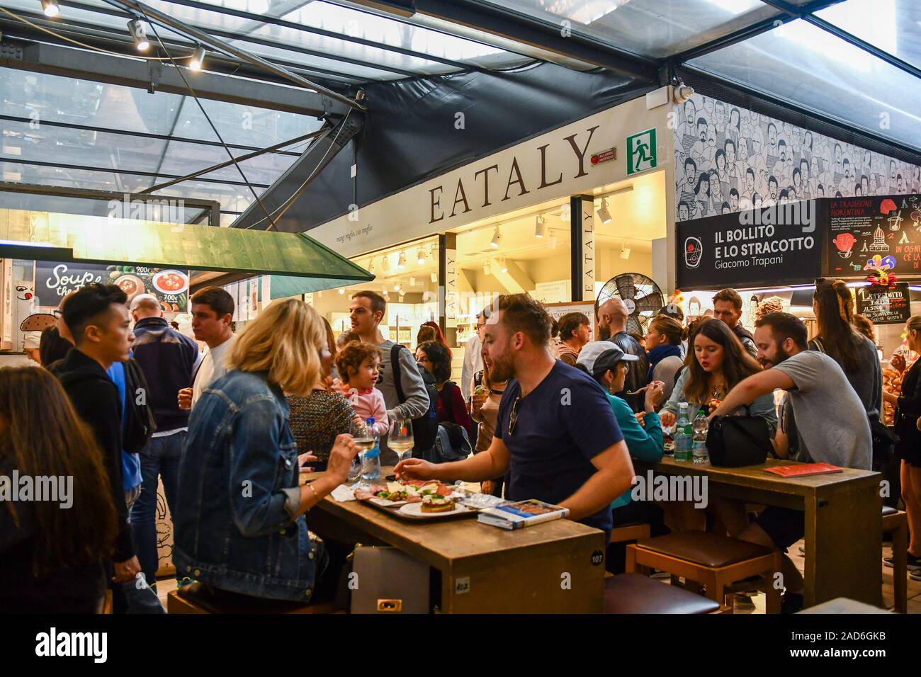 People and tourists enjoying lunch at San Lorenzo Central Market, a historic building in cast iron in the city center of Florence, Tuscany, Italy Stock Photo