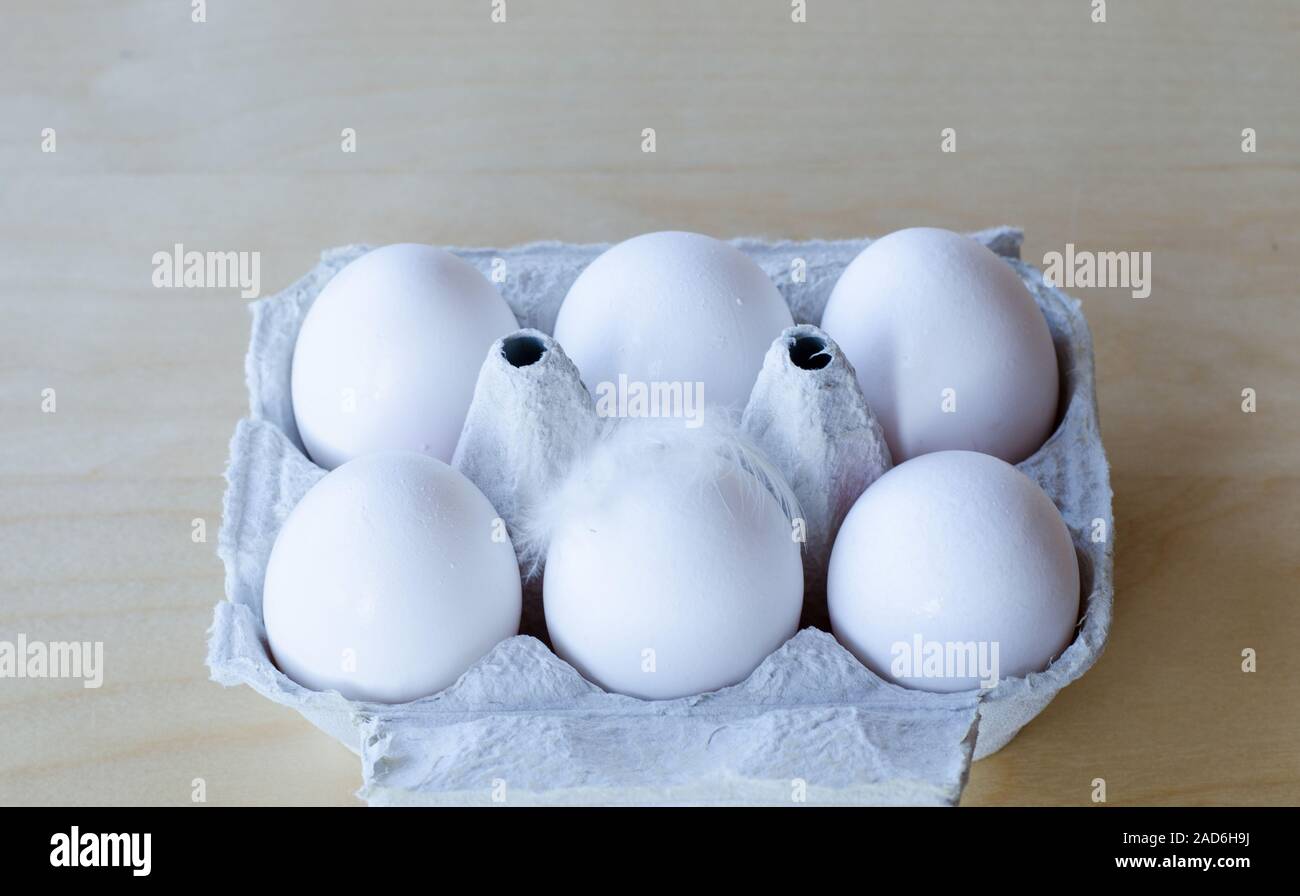White organic eggs in cartonbox on a table Stock Photo