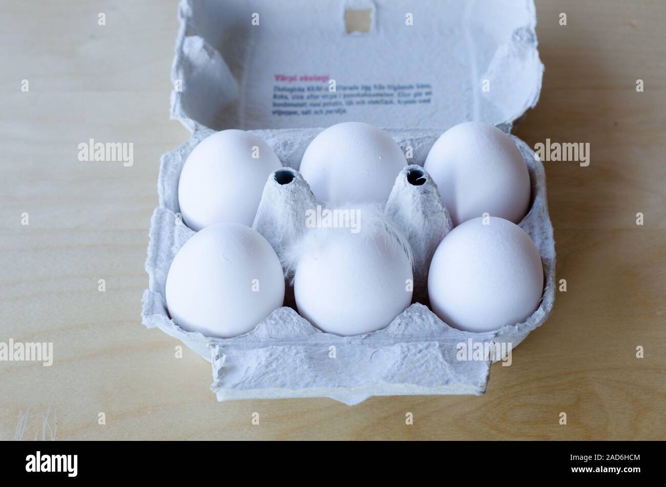 White organic eggs in cartonbox on a table Stock Photo