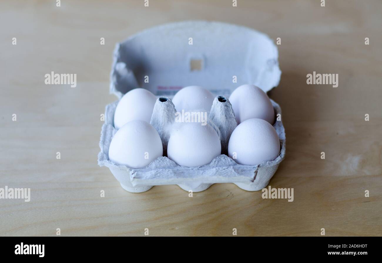 White organic eggs in cartonbox on a table Stock Photo
