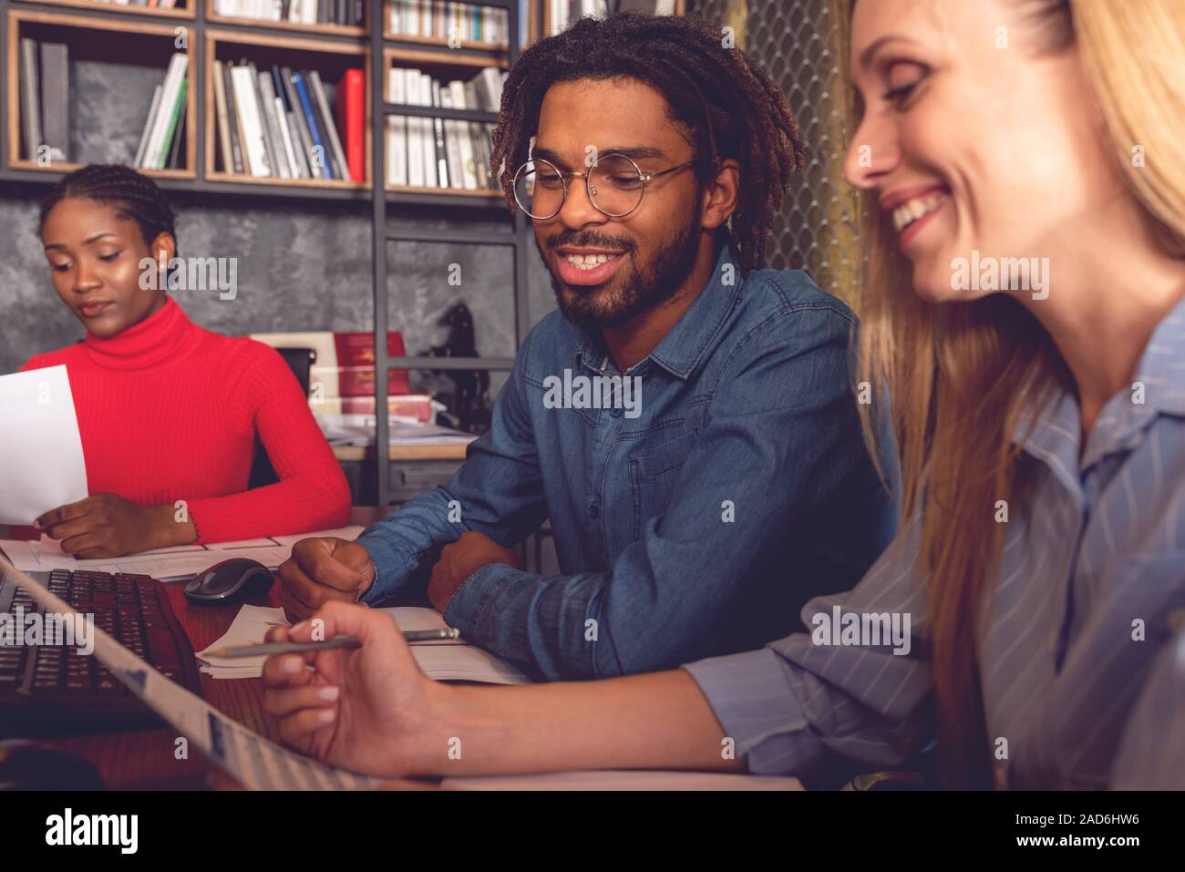 Young smiling business man and woman working together in the office ...