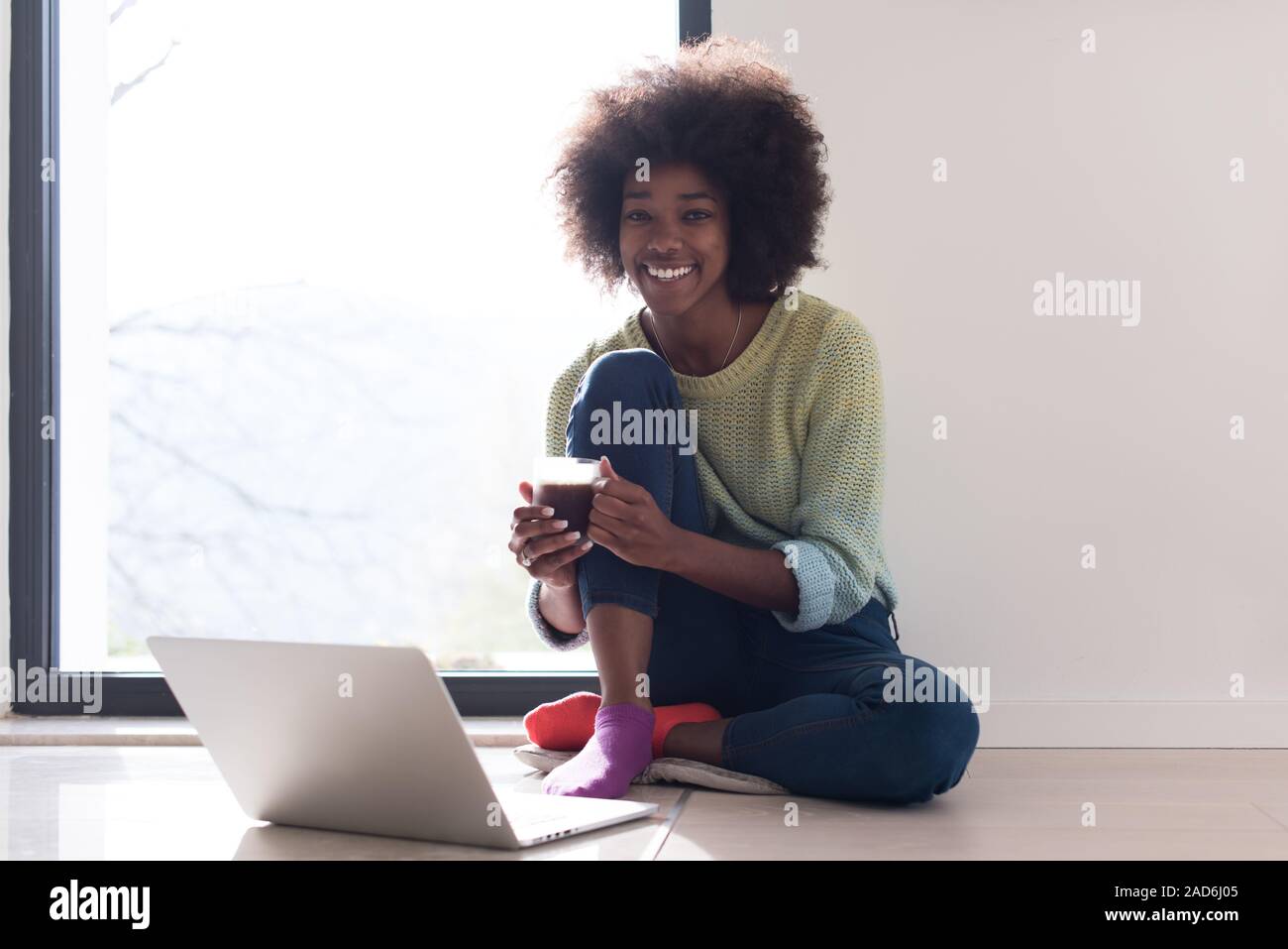 black woman in the living room on the floor Stock Photo - Alamy