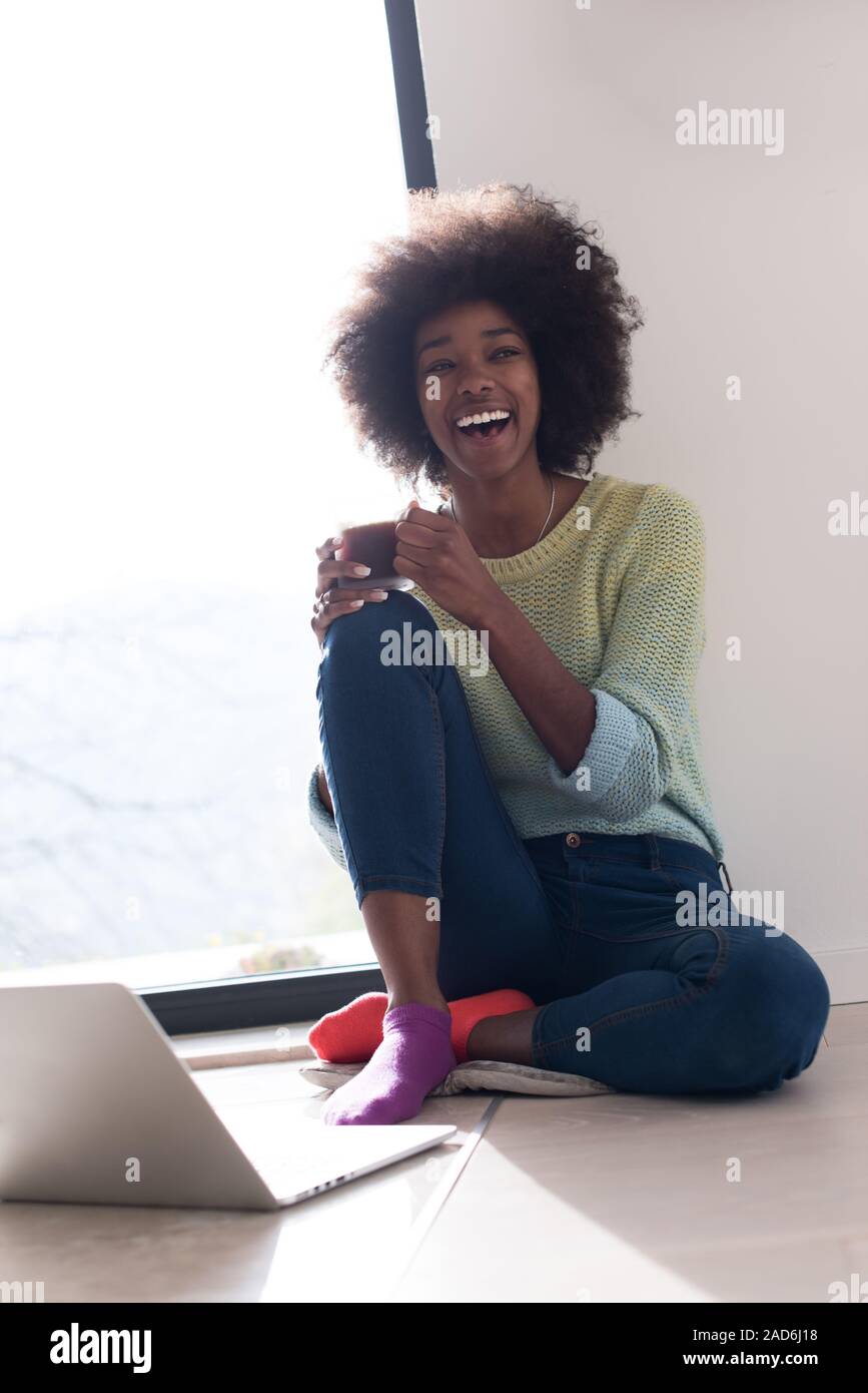 black woman in the living room on the floor Stock Photo - Alamy