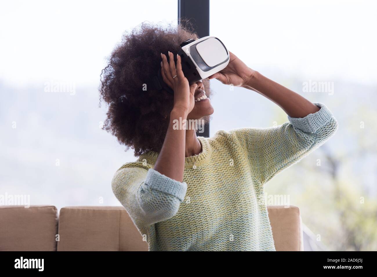 black woman using VR headset glasses of virtual reality Stock Photo - Alamy