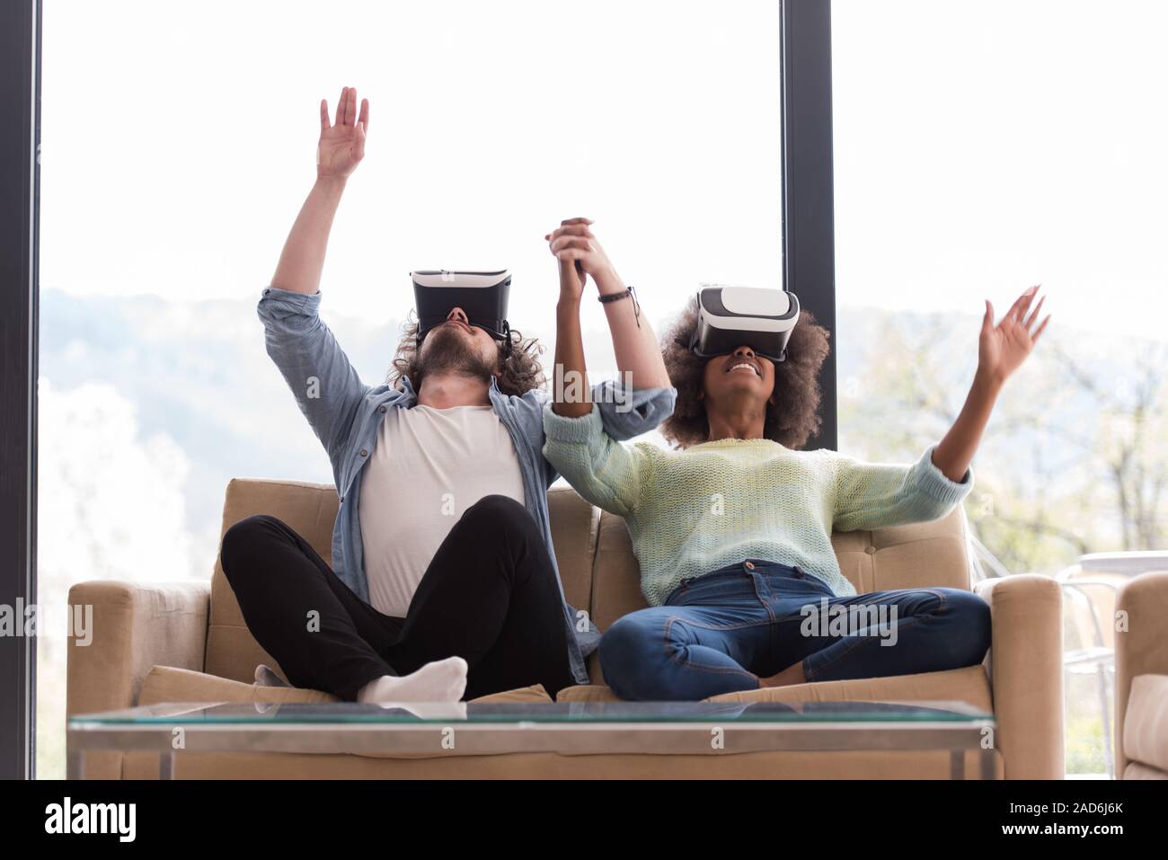 Multiethnic Couple using virtual reality headset Stock Photo - Alamy