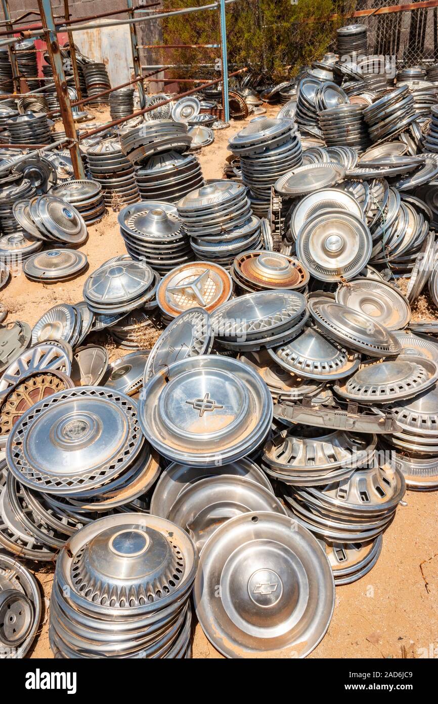 chrome wheel trims and hub caps in a junk yard in the desert in Phoenix