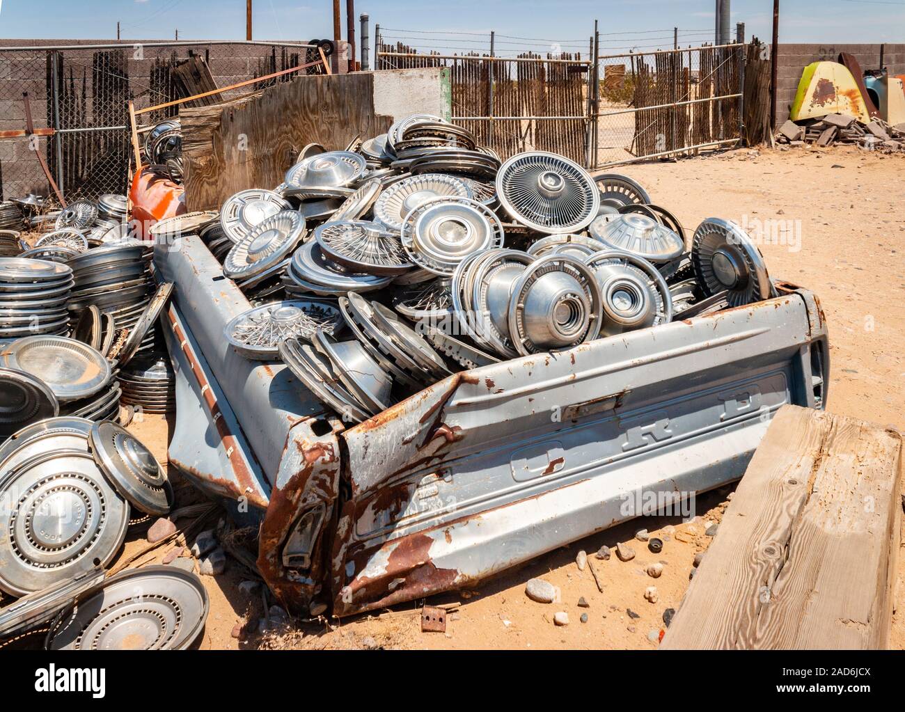 chrome wheel trims and hub caps in a junk yard in the desert in Phoenix