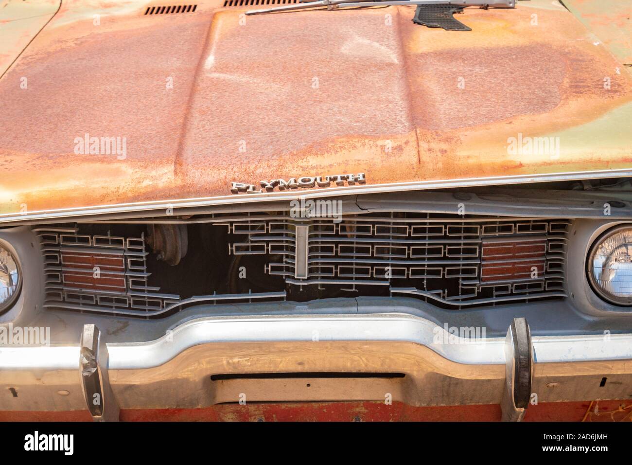 rusty old Plymouth car in a junk yard in the desert in Phoenix Arizona